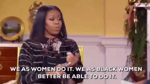 Political gif. Michelle Obama sits in a gold chair in front of a fireplace and talks to another woman, looking at her and counting off on her fingers as she says, "We as women do it. We as black women better be able to do it."