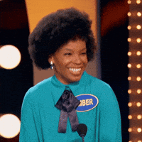 TV gif. Amber Ruffin, a comedian, is on Celebrity Family Feud. She throws her head back as she laughs and she grins winningly as she stands on stage.
