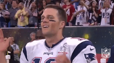Sports gif. Tom Brady claps and cheers, raises his hands and shouts "let's go."