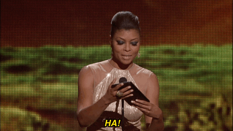 Celebrity gif. Holding a card on the stage at the BET Awards, Taraji P. Henson looks up with a smile and says, “HA!”