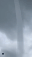 Waterspout Whips Up Sand on Florida Beach as it Moves Ashore