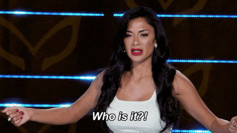 Reality TV gif. Nicole Scherzinger on the Masked Singer, bends her knees slightly, pulling clenched hands in towards her as she shouts in frustration, "who is it?"