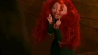 Disney gif. Merida hops excitedly, holding up her fists and smiling as her red curly hair bounces.
