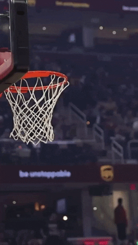 Sports gif. Slow motion video of Jayson Tatum of the Boston Celtics leaping into the air and slamming a basketball through a hoop with one hand.
