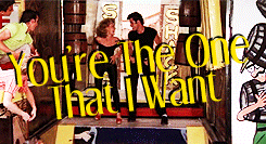 Sandy (Olivia Newton-John) and Danny (John Travolta) dance at the school carnival, with the caption "You're the One That I Want"