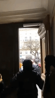 People Shelter in Doorways as Police Charge Through Paris Streets