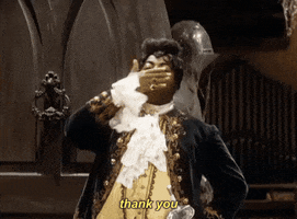 TV gif. Reginald VelJohnson as Carl on Family Matters wearing a 19th-century vampire costume, blows a dramatic kiss as he stands in the doorway of a spooky mansion.