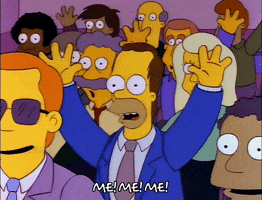 The Simpsons gif. A young Homer Simpson sits in a crowd, wearing a suit. He raises his hand and points to himself with his other hand, shouting, "Me! Me! Me!"