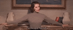 Movie gif. Cyd Charisse as Ninotchka Yoschenko in the movie Silk Stockings leans back against a mantle and says "facts are facts."