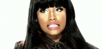 Celebrity gif. Nicki Minaj’s eyes flick back and forth inquisitively as she mouths, “hmmm.”