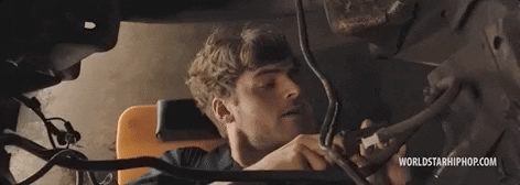 a mechanic working on the engines of a car