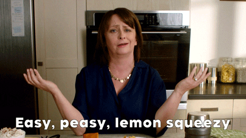 Woman mouthing the words "Easy, peasy, lemon squeezy" and snapping her fingers while she says it. 