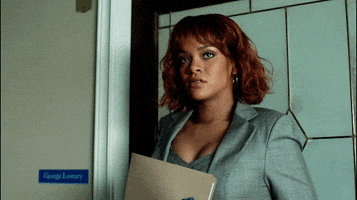 TV gif. Rihanna as Marion Crane on Bates Motel rolls her eyes and looks over her shoulder as she frustratedly thinks. She bites her bottom lip and walks away.