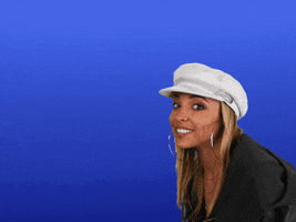 Celebrity gif. Tinashe smiles and waves coyly before pointing at us. Text, "Hi."