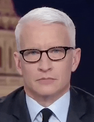 TV gif. A closeup of Anderson Cooper as he looks at us, blinks and rolls his eyes.  