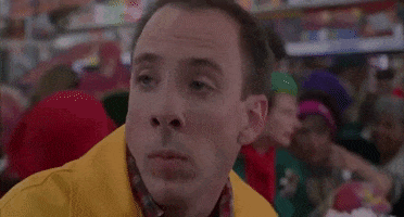 Movie gif. A Scene from Jingle All the Way. A man in a business Christmas store bursts out in loud laughter. 