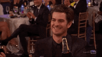 Celebrity gif. At an awards show, Andrew Garfield hoots and then raises his hands, clapping.