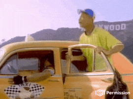 TV gif. Will Smith as Will in The Fresh Prince of Bel-Air, standing in front of the Hollywood Sign, hops onto a taxicab and points with enthusiasm, directing the driver to go.