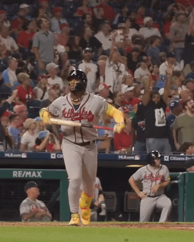 Sports gif. Ronald Acuna Jr of the Atlanta Braves jogs away from home plate as he points at someone and spreads his arms out like he's flying around the bases. 