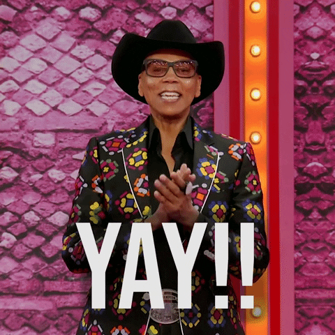 Celebrity gif. RuPaul stands in front of us excitedly and cheerfully as he clasps his hands together and says, "Yay!!"
